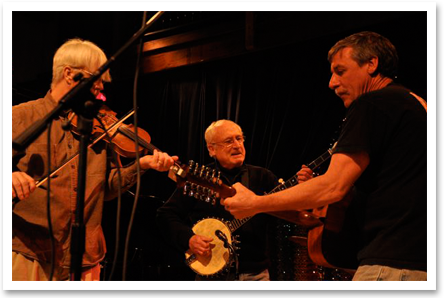 Andy performing at Acorn with Jim Harvey and a fiddle player